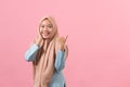 Portrait of Asian beautiful young muslim woman pointing a copy space with smile face Royalty Free Stock Photo