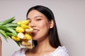 Portrait Asian beautiful young woman flowers spring posing light background unaltered Royalty Free Stock Photo