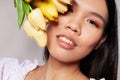 Portrait Asian beautiful young woman flowers spring posing light background unaltered Royalty Free Stock Photo