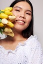 Portrait Asian beautiful young woman flowers spring posing light background unaltered Royalty Free Stock Photo