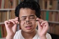 Portrait of Asian boy adjusting his eyeglasses, student with eye sight problem Royalty Free Stock Photo