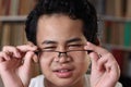 Portrait of Asian boy adjusting his eyeglasses, student with eye sight problem Royalty Free Stock Photo