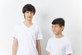 Portrait of Asian boy and caucasian teen on white background.