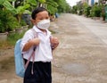 Portrait of Asian boy student in school uniform wearing a white shirt with backpack wearing mask go to school, back to school Royalty Free Stock Photo