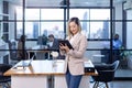 Portrait of Asian business CEO woman is standing in office at the table with digital tablet and showing statistic chart showing Royalty Free Stock Photo