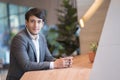 Portrait Asian business man drinking coffee in office during the break and looking at camera. Royalty Free Stock Photo