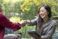 portrait asian business woman handshaking to businessman at outdoors coffee shop Royalty Free Stock Photo