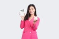 Portrait of an Asian business woman holding calculator and piggy bank isolated on white background, Business and financial concept Royalty Free Stock Photo