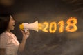 Portrait of asian business woman with megaphone shout 2018 in fire Royalty Free Stock Photo