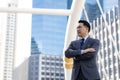 Portrait Asian businessman Confidence business man in full suit and looking away while standing outdoors with city background Royalty Free Stock Photo