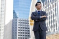 Portrait Asian businessman Confident adult business man in full suit and looking away while standing outdoors with cityscape Royalty Free Stock Photo