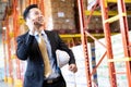 Portrait asian businessman making a call in distribution warehouse Royalty Free Stock Photo