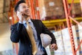 Portrait asian businessman making a call in distribution warehouse Royalty Free Stock Photo