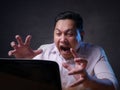 Asian Businessman Working on Laptop at the Office, Tired Stress Gesture Royalty Free Stock Photo