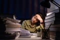 Portrait of Asian Businesswoman sitting and working hard at with front of computer and lots of documents on the table in workplace Royalty Free Stock Photo