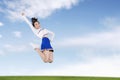 Asian cheerleader girl jumping in the field Royalty Free Stock Photo