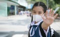 Portrait Asian children girl wear mask to protect PM 2.5 dust and air pollution. Portrait of Thai student wearing protection mask