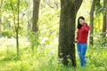 Portrait of a Asian Chinese free woman reading book and listening to music in spring autumn park in forest Royalty Free Stock Photo