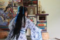 Portrait of Asian Chinese girl in traditional dress, wear blue and white porcelain style Hanfu, do housework in a ancient kitchen Royalty Free Stock Photo