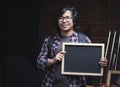 Portrait of Asian College Student Holding Blackboard Inside Ware Royalty Free Stock Photo