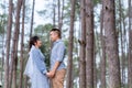 Portrait Of An Asian Couple Posing For A Pre-wedding Photo In Identical Blue Outfits, Happily Showing Off Their Expressions Of