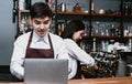 Portrait of Asian couple small business owner using laptop at counter bar in cafe, Service mind and Startup Owner small business