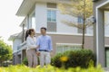 Portrait of Asian couple walking and hugging together looking happy in front of their new house to start new life. Family, age, Royalty Free Stock Photo