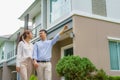 Portrait of Asian couple walking and hugging together looking happy in front of their new house to start new life. Family, age, Royalty Free Stock Photo