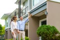 Portrait of Asian couple walking and hugging together looking happy in front of their new house to start new life. Family, age, Royalty Free Stock Photo