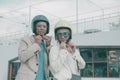 portrait of asian couples wearing safety helmet on city street Royalty Free Stock Photo