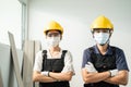 Portrait of Asian Craftsman or Carpenter builder people look at camera. Construction worker wear safety helmet and protective mask