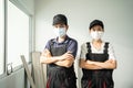 Portrait of Asian Craftsman or Carpenter worker man and woman wear safety helmet and protective mask, crossed arm and look at