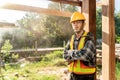 Portrait of Asian craftsman with holding a hammer in hands standing in spacious workshop and looking at camera on construction