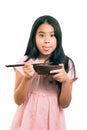 Portrait of Asian cute girl eating, using chopsticks ,isolated on white Royalty Free Stock Photo