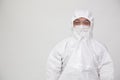 Portrait of Asian doctor or nurse in Personal Protective Equipment or PPE suit and wearing face mask and eyeglasses Royalty Free Stock Photo