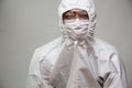 Portrait of Asian doctor or nurse in Personal Protective Equipment or PPE suit and wearing face mask and eyeglasses Royalty Free Stock Photo