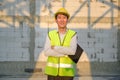 Portrait of An Asian Engineering man wearing safety helmet checking construction site analyzing about project progress Royalty Free Stock Photo