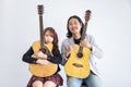 Portrait of Asian family duo band with two guitarist of father and daughter on white background for music, artist, musician style