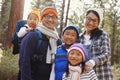 Portrait of an Asian family of five in a forest setting