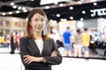 Portrait of Asian female car seller wearing face shield selling car