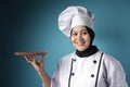 Asian Female Chef Shows Empty Wooden Plate, Presenting Something, Copy Space Royalty Free Stock Photo