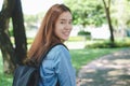 Portrait of asian female colleges student holding textbook in her hands and standing outdoors at university campus Royalty Free Stock Photo