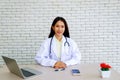 Female doctor sitting at a desk in a hospital office. Royalty Free Stock Photo