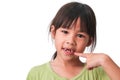 Portrait of an Asian girl with broken upper baby teeth and first permanent teeth. Friendly little girl showing her broken teeth