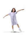 Portrait of Asian girl child stand on one leg with looking camera and arms outstretched on white background. Full body image with Royalty Free Stock Photo