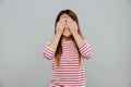 Portrait of an asian girl covering her face with hands Royalty Free Stock Photo