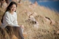 Portrait of asian girl relaxing emotion sitting in grass field a Royalty Free Stock Photo