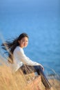 Portrait of asian girl relaxing emotion sitting in grass field a Royalty Free Stock Photo