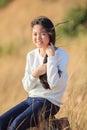 Portrait of asian girl relaxing emotion sitting in grass field a Royalty Free Stock Photo