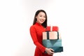 Portrait of an Asian girl in a traditional Vietnamese dress, ao dai, a good smile, holding gift box Royalty Free Stock Photo